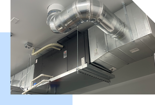 A room with an air conditioning unit hanging from the ceiling provided by Maui HVAC Services.