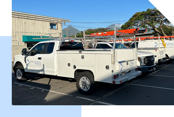 A group of white trucks parked in a parking lot providing Maui Hvac Services.