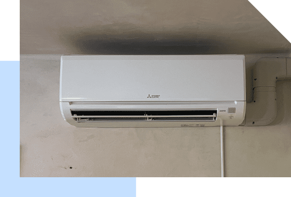 A white air conditioner hanging on a wall, providing AC Services On Maui.